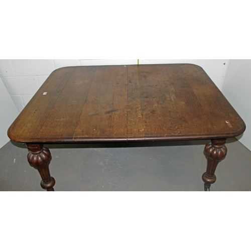 57 - A Victorian oak dining table with impressive carved legs