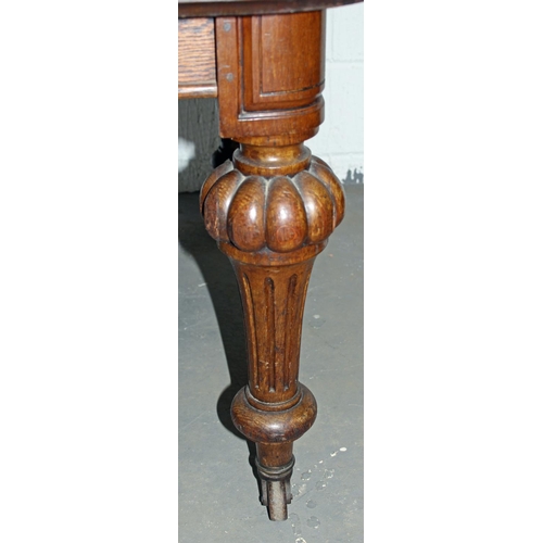 57 - A Victorian oak dining table with impressive carved legs