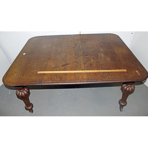 57 - A Victorian oak dining table with impressive carved legs