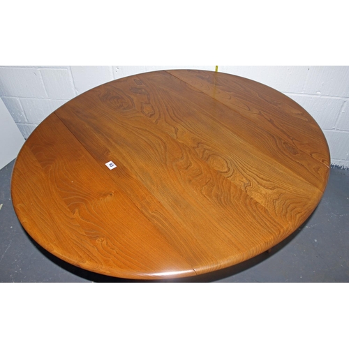 95 - A Blonde Ercol drop leaf circular dining table