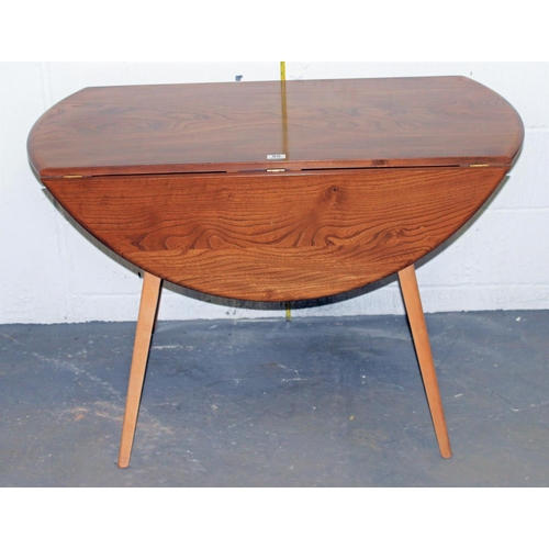 95 - A Blonde Ercol drop leaf circular dining table