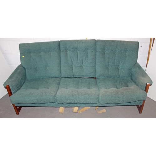 96 - A retro green upholstered show frame sofa, 2 chairs and a foot stool in the manner of Ercol