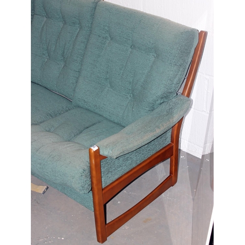 96 - A retro green upholstered show frame sofa, 2 chairs and a foot stool in the manner of Ercol