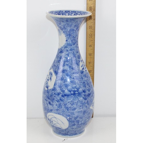 1671 - A 20th century Japanese blue and white decorated with floral vignettes - signed verso