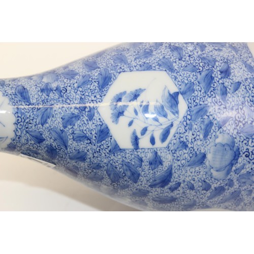 1671 - A 20th century Japanese blue and white decorated with floral vignettes - signed verso