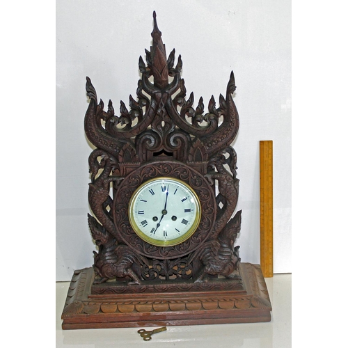 1457 - A highly impressive early 20th century carved hardwood mantle clock in the Anglo-Indian style. Profu... 