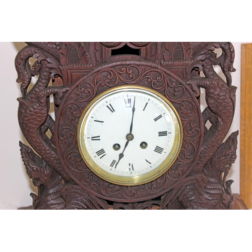 1457 - A highly impressive early 20th century carved hardwood mantle clock in the Anglo-Indian style. Profu... 