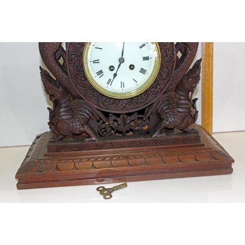 1457 - A highly impressive early 20th century carved hardwood mantle clock in the Anglo-Indian style. Profu... 