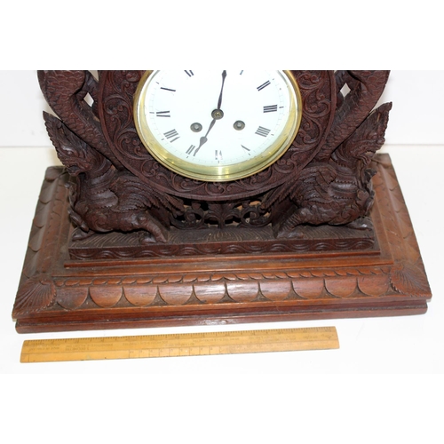 1457 - A highly impressive early 20th century carved hardwood mantle clock in the Anglo-Indian style. Profu... 