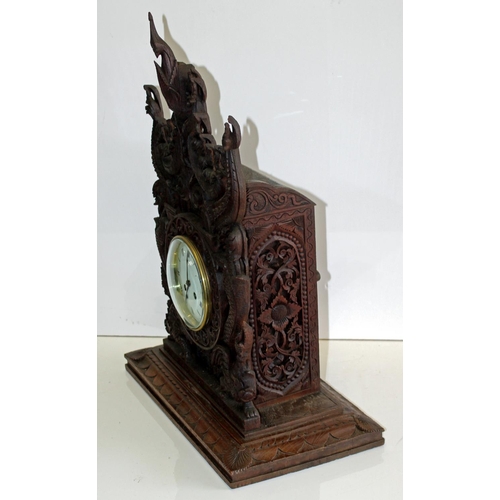 1457 - A highly impressive early 20th century carved hardwood mantle clock in the Anglo-Indian style. Profu... 