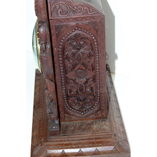 1457 - A highly impressive early 20th century carved hardwood mantle clock in the Anglo-Indian style. Profu... 