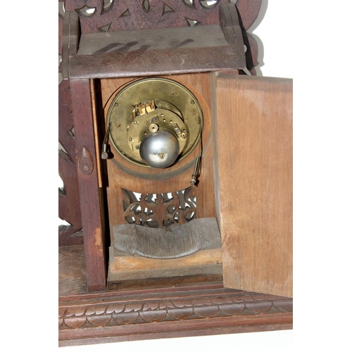 1457 - A highly impressive early 20th century carved hardwood mantle clock in the Anglo-Indian style. Profu... 