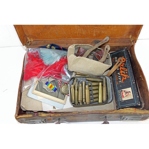 1048 - A vintage suitcase containing a large qty of military items and ephemera to inc badges and buttons