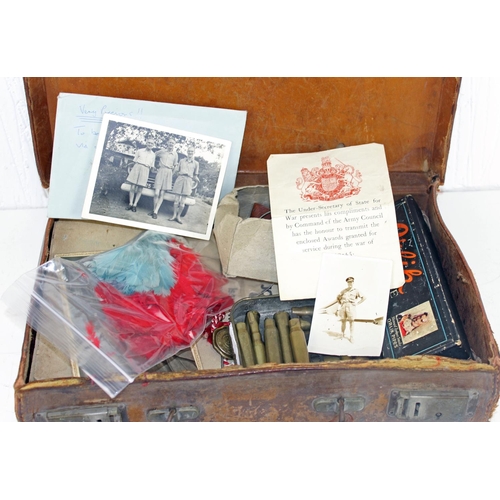 1048 - A vintage suitcase containing a large qty of military items and ephemera to inc badges and buttons