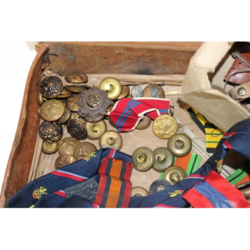 1048 - A vintage suitcase containing a large qty of military items and ephemera to inc badges and buttons