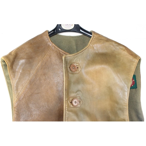 1067 - A 1941 dated WW2 period Camouflage Leather Jerkin by Hector Powe with a large qty of fabric patches ... 