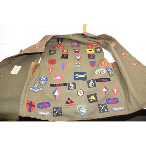 1067 - A 1941 dated WW2 period Camouflage Leather Jerkin by Hector Powe with a large qty of fabric patches ... 