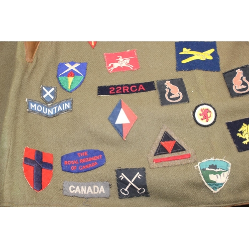 1067 - A 1941 dated WW2 period Camouflage Leather Jerkin by Hector Powe with a large qty of fabric patches ... 