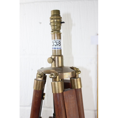 338 - A wooden tripod lamp with brass mounts