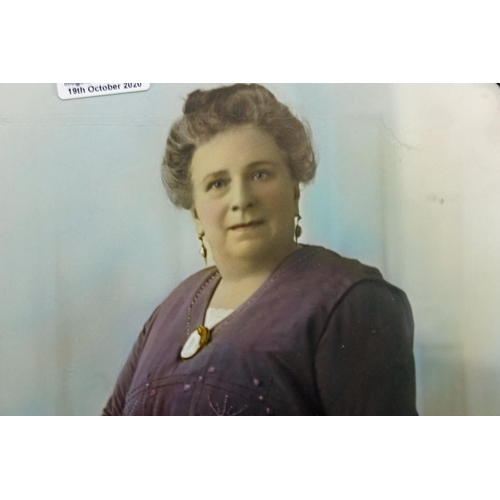 521 - An Edwardian gilt framed photograph of a lady with coloured highlights