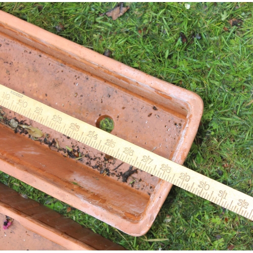 631 - A pair of terracotta garden planter troughs