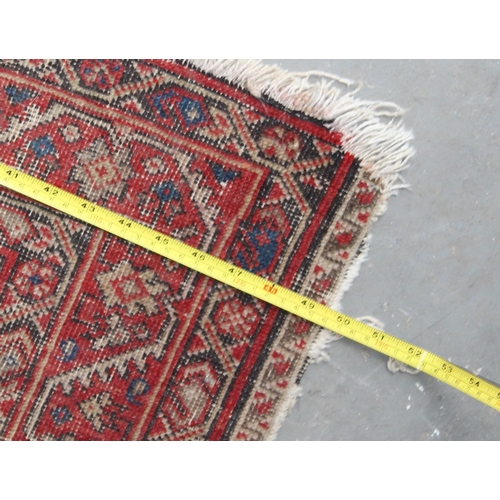 203 - A Mashad style rug on red ground with repeating geometric patterns - likely Persian - purchased from... 