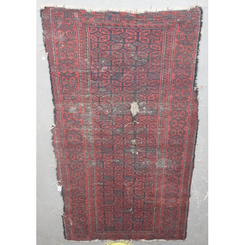 204 - An antique red ground rug decorated with and optical illusion of repeating gul - purchased from Harr... 