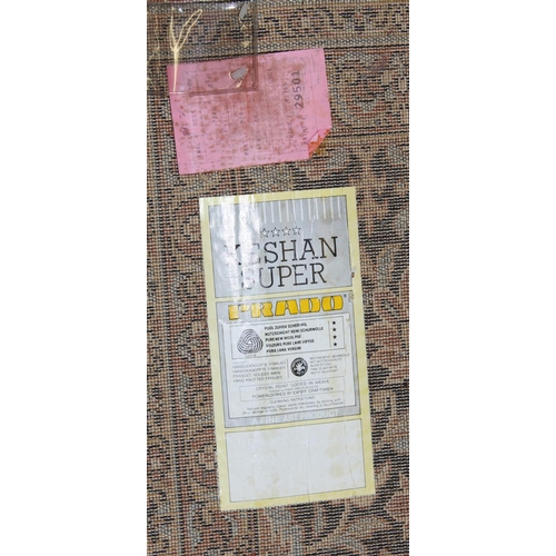 205 - A large modern Super Keshan Prado wool rug of beige ground with Arabesque decoration