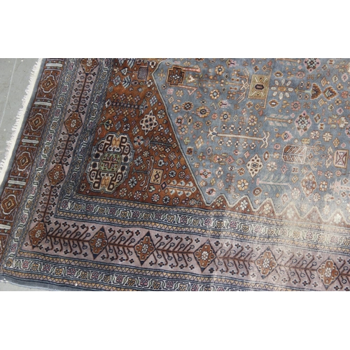 207 - A vintage blue and red ground Saruq style rug decorated profusely