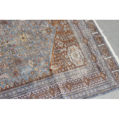 207 - A vintage blue and red ground Saruq style rug decorated profusely