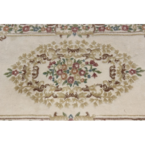 208 - An Indian made thick pile rug rug of beige ground