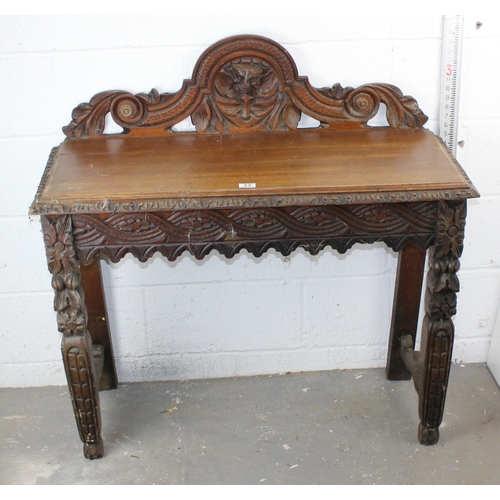 22 - A Victorian Gothic Revival period hall table with carved details in high relief