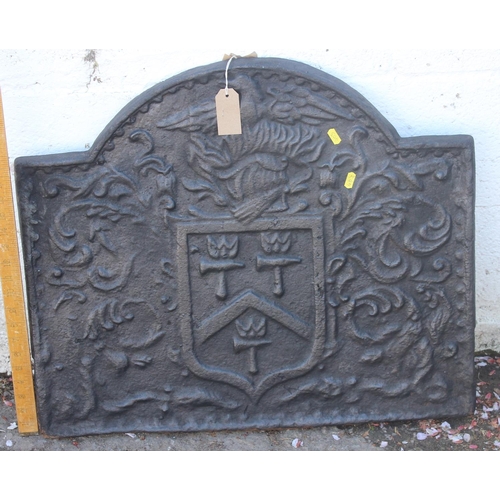 275 - A cast iron fire back of some age depicting a Phoenix and armorial crest