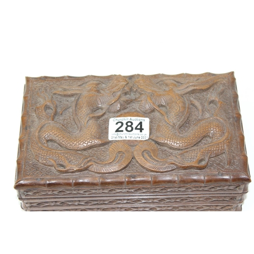 284 - A Chinese carved wooden box decorated with dragons