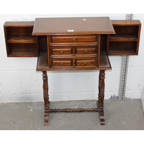 4 - A 20th century cabinet on stand believed to be a jewellery cabinet with opening sides and 3 drawers