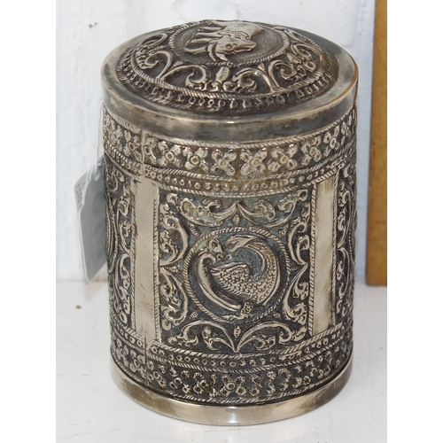 1138 - An Indian white metal lidded pot with embossed decoration