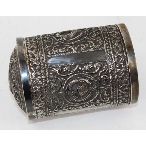 1138 - An Indian white metal lidded pot with embossed decoration