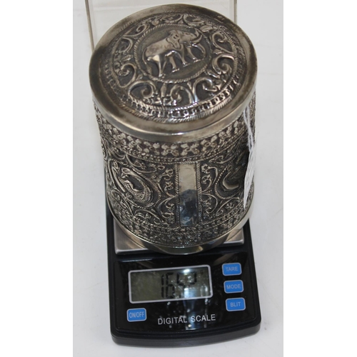 1138 - An Indian white metal lidded pot with embossed decoration