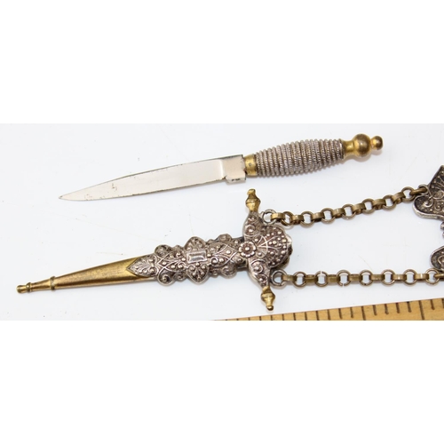 1216 - A white metal and brass dagger in sheath with classical design. Believed to be a seam knife from a C... 