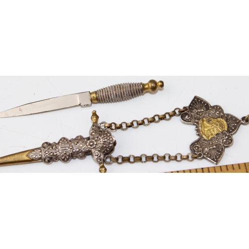 1216 - A white metal and brass dagger in sheath with classical design. Believed to be a seam knife from a C... 