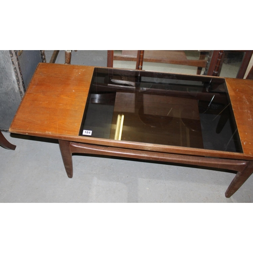 184 - A retro teak and smoked glass coffee table