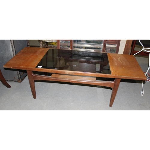 184 - A retro teak and smoked glass coffee table