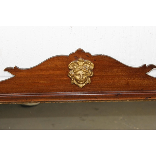 392 - A George III style fretwork mirror with gilt mask decoration