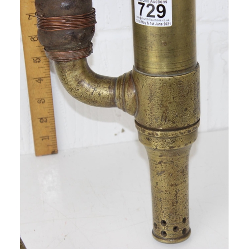 729 - An antique brass pump with unusual leather hose attachment