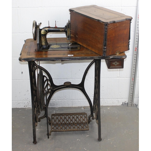 75 - Antique sewing machine table with cast-iron base, probably by Singer