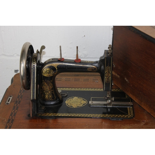 75 - Antique sewing machine table with cast-iron base, probably by Singer