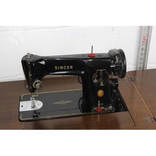 95 - A vintage Singer 201k sewing machine table and attachments