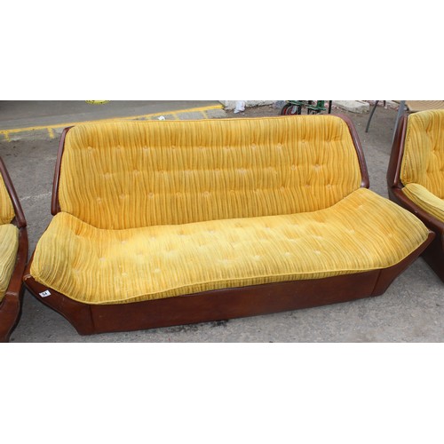 54 - An unusual retro 1970's sofa with mustard coloured button back fabric and brown vinyl base - no make... 