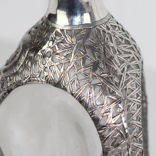 1110 - A vintage silver mounted Dimple Haig whisky bottle with pierced silver overlay decorated in the Chin... 