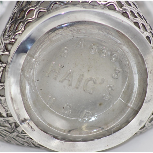 1110 - A vintage silver mounted Dimple Haig whisky bottle with pierced silver overlay decorated in the Chin... 